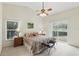 Relaxing main bedroom featuring vaulted ceilings, soft carpet and a view to the lush outdoors at 5849 Groveline Dr, Orlando, FL 32810