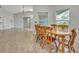 Dining room connected to the living room with natural wood table set at 609 Bluebill Ln, Kissimmee, FL 34759