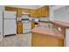 Kitchen featuring matching white appliances, cabinets, and neutral countertops at 609 Bluebill Ln, Kissimmee, FL 34759