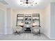 Bedroom featuring stylish black shelving, two desks, two chairs and an interesting light fixture at 6406 Tabebuia Pkwy, Winter Garden, FL 34787