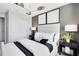 Bedroom featuring a padded headboard, decorative wallpaper and modern, eye-catching light fixture at 6406 Tabebuia Pkwy, Winter Garden, FL 34787