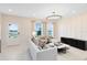 Bright living room with a modern chandelier, neutral furniture and plenty of natural light at 6406 Tabebuia Pkwy, Winter Garden, FL 34787