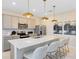 Modern kitchen featuring stainless appliances, a quartz countertop island with seating and pendant lighting at 6412 Tabebuia Pkwy, Winter Garden, FL 34787