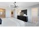 Bright main bedroom with a modern dresser, an open ensuite bathroom, and contemporary lighting at 6412 Tabebuia Pkwy, Winter Garden, FL 34787