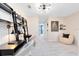 Bright, modern study area with built-in shelving, a comfortable chair, and neutral colors for a peaceful workspace at 6412 Tabebuia Pkwy, Winter Garden, FL 34787