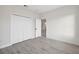 Bedroom features light gray wood-look flooring and closet with white doors at 6430 Sw 145Th Ln, Ocala, FL 34473