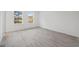 Well-lit bedroom featuring gray wood flooring, white walls, and windows at 6430 Sw 145Th Ln, Ocala, FL 34473