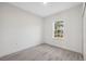 Bright bedroom with wood-look flooring and a view from the window at 6430 Sw 145Th Ln, Ocala, FL 34473