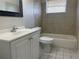 This bathroom features neutral tile, a shower-tub combo, and a single sink vanity at 709 Michigan Ct # 4, St Cloud, FL 34769