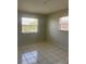 Well-lit room with neutral tones, features tiled floor, and natural light from two windows with blinds at 709 Michigan Ct # 4, St Cloud, FL 34769