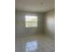 Bedroom featuring tile floors, neutral walls and a bright window at 709 Michigan Ct # 4, St Cloud, FL 34769