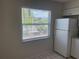 Bright kitchen featuring white refrigerator and window at 709 Michigan Ct # 4, St Cloud, FL 34769