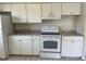 Bright kitchen with white cabinets and appliances at 709 Michigan Ct # 4, St Cloud, FL 34769