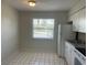 Bright kitchen with white appliances and tile flooring and a window view at 709 Michigan Ct # 4, St Cloud, FL 34769