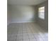 An empty living room featuring tile floors, neutral walls and a bright window at 709 Michigan Ct # 4, St Cloud, FL 34769