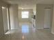 A bright and airy living room with tile floors, neutral paint, and a view into the kitchen at 709 Michigan Ct # 4, St Cloud, FL 34769