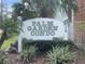 Palm Garden Condo sign surrounded by trimmed bushes and palm trees at 709 Michigan Ct # 4, St Cloud, FL 34769