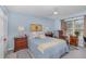 Bright bedroom features a ceiling fan, a window offering natural light, and bedside tables at 8121 Deville Ct, Orlando, FL 32817