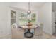 Bright breakfast nook features a round table, stylish light fixture, and window views at 8121 Deville Ct, Orlando, FL 32817