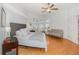 Bright main bedroom features high ceilings, a ceiling fan, and an upholstered headboard at 8121 Deville Ct, Orlando, FL 32817