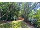 Scenic wooded walking path near the lake with lush foliage and access to community amenities at 8121 Deville Ct, Orlando, FL 32817