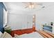 Bright bedroom features hardwood floors, ceiling fan, closet and blue accent wall at 1002 Versailles Ct, Maitland, FL 32751