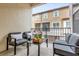 Cozy balcony with seating, flower centerpiece and views of the neighborhood at 1012 Parma Cir, Lake Mary, FL 32746