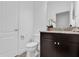 Clean bathroom with tiled floors, dark vanity with granite countertop, and a well-lit mirror at 1012 Parma Cir, Lake Mary, FL 32746