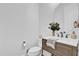 A charming half bathroom featuring a round mirror and modern fixtures at 1012 Parma Cir, Lake Mary, FL 32746