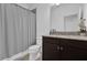 This bathroom has an espresso vanity, granite counters, tiled shower with a shower curtain at 1012 Parma Cir, Lake Mary, FL 32746