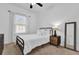 This bedroom is freshly painted with a modern black metal frame bed and light brown nightstand at 1012 Parma Cir, Lake Mary, FL 32746