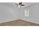 This bright bedroom features neutral carpet, a ceiling fan, and a window for natural light at 1012 Parma Cir, Lake Mary, FL 32746