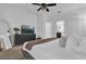 View of the spacious bedroom featuring a large TV, ceiling fan, and carpet flooring at 1012 Parma Cir, Lake Mary, FL 32746