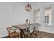 Modern dining room featuring a stylish light fixture and seating for six at 1012 Parma Cir, Lake Mary, FL 32746