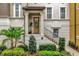 Inviting front entrance featuring a classic design, well-maintained landscaping, and decorative wrought iron railing at 1012 Parma Cir, Lake Mary, FL 32746
