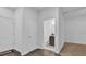 Bright hallway with fresh white paint, opening to a bathroom with modern fixtures and a dark vanity at 1012 Parma Cir, Lake Mary, FL 32746