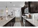 A modern kitchen boasts granite counters, stainless appliances, and dark wood cabinets at 1012 Parma Cir, Lake Mary, FL 32746