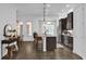 Modern kitchen with a large center island, bar seating, stainless steel appliances, and hardwood flooring at 1012 Parma Cir, Lake Mary, FL 32746