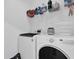Modern laundry room features a new washer, dryer, and storage shelves at 1012 Parma Cir, Lake Mary, FL 32746