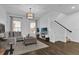 Bright living room featuring modern decor, hardwood floors, stylish ottoman, and a comfortable gray sofa at 1012 Parma Cir, Lake Mary, FL 32746