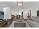 Spacious open-concept living space flowing into a modern kitchen with a large island and bar seating at 1012 Parma Cir, Lake Mary, FL 32746