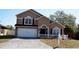 Charming two-story home featuring a manicured front yard and a bright white garage door at 1106 Blackwood Way, Clermont, FL 34714