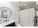 Bathroom featuring a shower with white tile and accents, a round mirror, and a toilet at 1109 Clubside Dr # 1109, Longwood, FL 32779