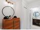 Bathroom featuring a round mirror, white walls, and stylish decor on a wooden dresser at 1109 Clubside Dr # 1109, Longwood, FL 32779