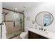 Bathroom featuring a glass shower door, round mirror, white countertop, and decorative accents at 1109 Clubside Dr # 1109, Longwood, FL 32779