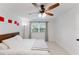 Bedroom featuring white walls, a ceiling fan, a window with curtains, and a comfortable bed at 1109 Clubside Dr # 1109, Longwood, FL 32779