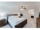 Cozy bedroom features wooden accents, soft bedding, and ensuite bathroom at 1109 Clubside Dr # 1109, Longwood, FL 32779
