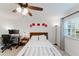 Bedroom featuring white walls, a ceiling fan, a desk, and a window with curtains allowing natural light at 1109 Clubside Dr # 1109, Longwood, FL 32779