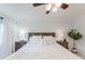 Bright bedroom features a wood accent wall, ceiling fan, and neutral decor, creating a cozy and inviting atmosphere at 1109 Clubside Dr # 1109, Longwood, FL 32779