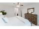 Bedroom with a ceiling fan, white walls, a wooden dresser with a mirror, and a decorative plant at 1109 Clubside Dr # 1109, Longwood, FL 32779